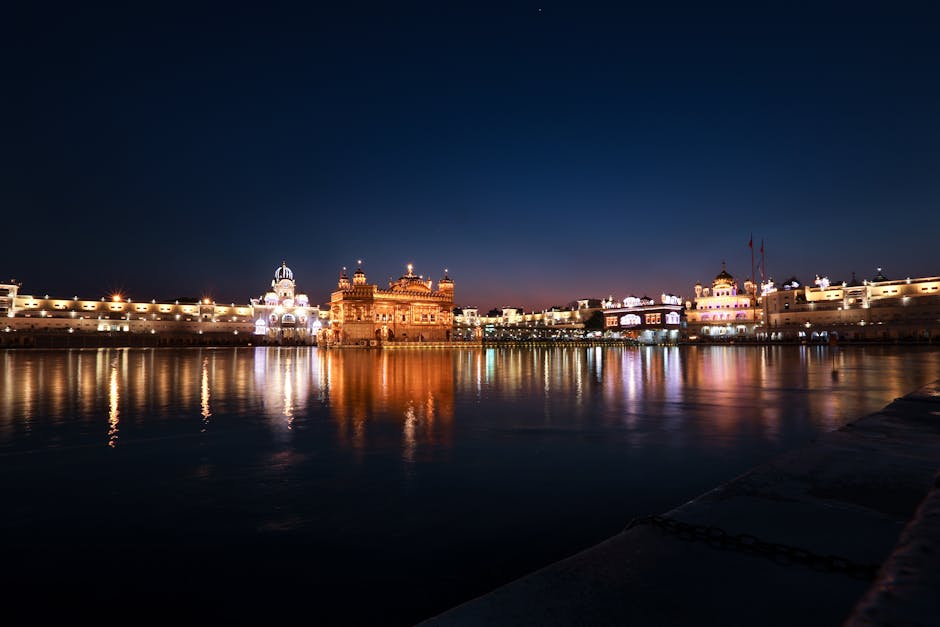 Stunning view of the Golden Temple reflecting in water at dusk, in Amritsar, India.